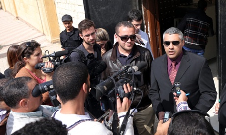 Al-Jazeera journalists Mohammed Fahmy (right) and Baher Mahmoud (left) speak to reporters outside a courthouse after their trial session in Cairo where prosecution witnesses failed to appear.