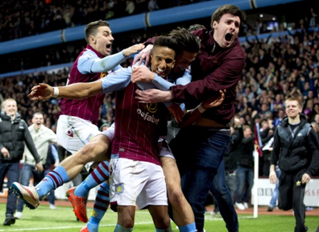 Aston Villa fans invade the pitch to celebrate with goalscorer Scott Sinclair.
