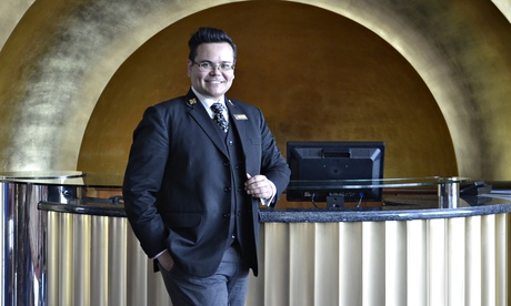 Every other word he utters is a luxury brand … Oscar the concierge in his golden cave. Photograph: R