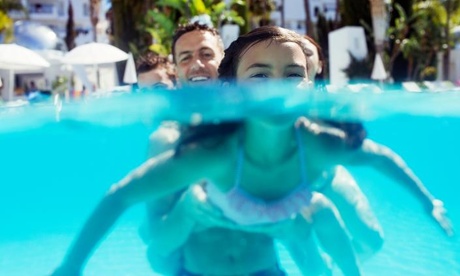 Father and daughter in pool, holidays