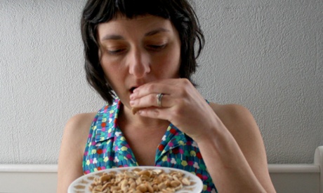 Becky Striepe eating dry roasted cashew nuts.