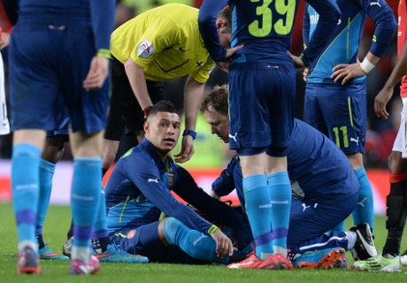 Alex Oxlade-Chamberlain receives treatment before being substituted.