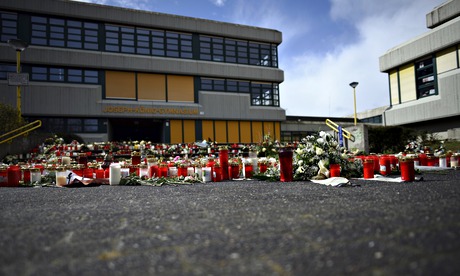 A memorial of flowers and candles is pic