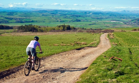 Mountain biker descending on Caton Moor above Hornby in the Lune valley.