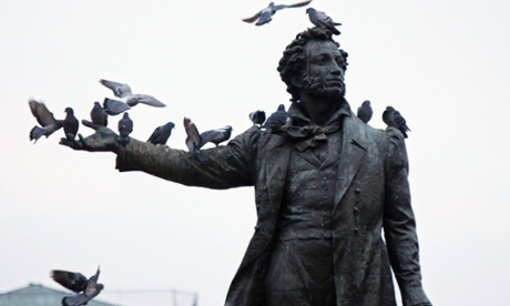 Birds perch on the monument of famous Russian poet Aleksander Pushkin, in front of the Russian Museum, in St Petersburg