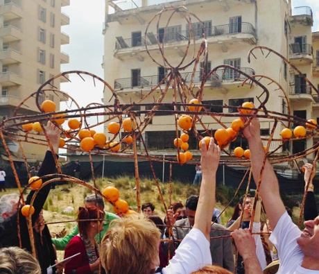 Turkish and Greek Cypriot activists decorate an old Famagusta orange festival float.