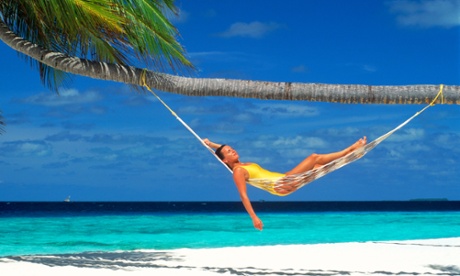 Woman sunbathing in a hammock