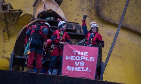 Greenpeace activists hold a banner that reads 'The People vs. Shell' as they scaled the Polar Pioneer drill rig in the Pacific Ocean.  Six Greenpeace climbers have intercepted an Arctic-bound Shell oil rig in the middle of the Pacific Ocean, 750 miles north-west of Hawaii and have scaled the 38,000 tonne platform.  At dawn this morning, the six, from the USA, Germany, New Zealand, Australia, Sweden and Austria, sped towards the Polar Pioneer, which Shell intends to use to drill for oil in the Chukchi Sea, in inflatable boats launched from the Greenpeace ship Esperanza.