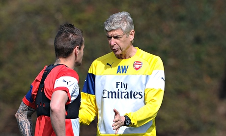 Arsenal manager, Arsène Wenger, talking to Mathieu Debuchy during training at London Colney