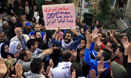 Palestinians with a placard reading 'Yarmouk camp ... we need you to stop the barrel bombs' demonstrate in a refugee camp near Sidon, Lebanon.