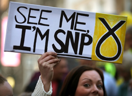 An activist holds a sign as SNP leader and first minister Nicola Sturgeon campaigns in Stirling.