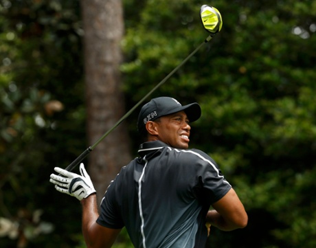 Tiger Woods of the U.S. lets go of his driver as he follows through on his tee shot.
