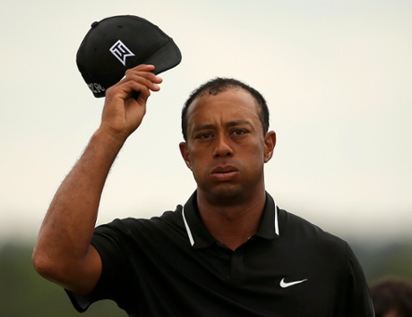 Tiger Woods takes his cap off as he walks off the 18th.