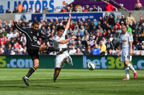 Aaron Lennon scores the first goal as Jack Cork attempts to block.