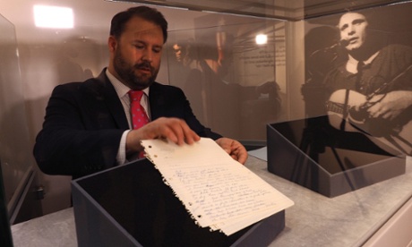 A curator handles the original handwritten lyrics to the song American Pie by Don McLean, which are to be auctioned at Christie's in New York.