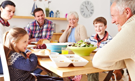 Multi Generation Family Eating Lunch At Kitchen Table