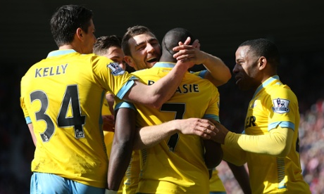 Crystal Palace's French-born Congolese midfielder Yannick Bolasie (C #7) is congratulated after scoring during the English Premier League football match between Sunderland and Crystal Palace at the Stadium of Light in Sunderland, northeast England, on April 11, 2015. AFP PHOTO / IAN MACNICOL  RESTRICTED TO EDITORIAL USE. No use with unauthorized audio, video, data, fixture lists, club/league logos or live services. Online in-match use limited to 45 images, no video emulation. No use in betting, games or single club/league/player publications. Ian MacNicol/AFP/Getty ImagesEnglish Premier LeagueFootballSoccerClub SoccerEnglish Soccer ClubBallTeam Sport