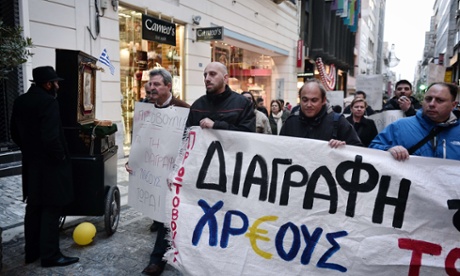 Protesters in Athens call for the debts to be written off.