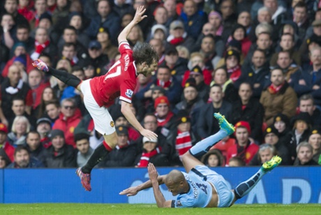 Vincent Kompany tackles Daley Blind earning himself a yellow card.