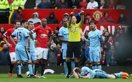 James Milner lies injured.