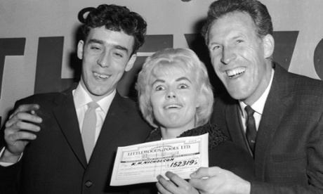 Bruce Forsyth, right, presents Viv Nicholson and her husband, Keith, with a cheque from Littlewoods in 1961.