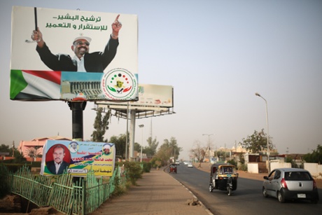 Vehicles drive past an election campaign banner in support of President Omar al-Bashir in Omdurman, which reads “Nominating al-Bashir, for stability and reconstruction”. 