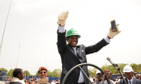 Chad’s president, Idriss Deby, holds a glass filled with oil in Badila, southern Chad, during the opening of an oil valve operated by Canadian oil explorer Caracal Energy.