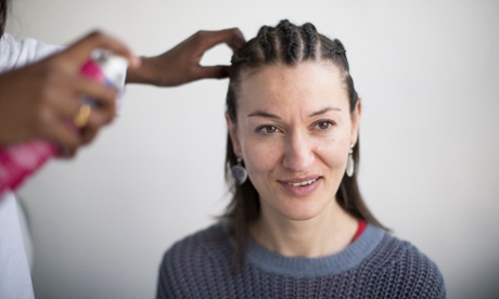 Lauren Cochrane having her hair braided.