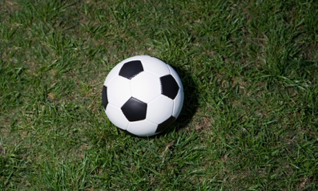 Close-up of 1970's style Black and White Football on grass
