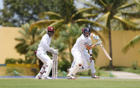 West Indies' Denesh Ramdin looks on as Joe Root steers a delivery away.