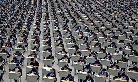 Students take an examination on an open-air playground at a high school in Yichuan