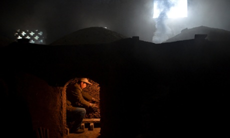 A worker burns bamboo charcoal at a mill at Huoshan county, Anhui province, China.