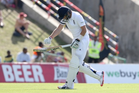 Joe Root punches his bat as he walks off after losing his wicket.