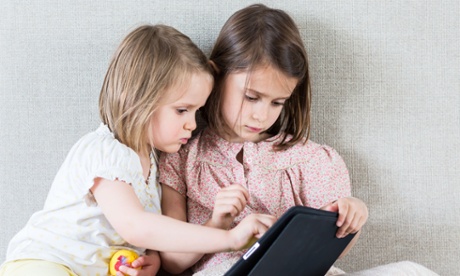 29 May 2013 --- Girls using iPad . --- Image by   Voisin/phanie/Phanie Sarl/Corbis2-6 year oldchildcomputercomputer hardwarecomputer technologycomputeringfemalefurnituregamegirlindoorsiPadlaptopleisurepeoplepersonal computerrecreationseatseating furnituresiblingssibshipsistersittingsofatablet PCtechnologytwotwo peoplevideo game