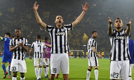 Patrice Evra, left, Leonardo Bonucci, centre, and Arturo Vidal celebrate after beating Borussia Dortmund 3-0 away in the Champions League round of 16.
