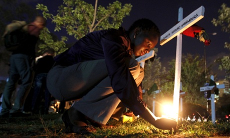 A woman lights a candle in Nairobi at a memorial to remember the Garissa University students killed by al-Shabaab. 