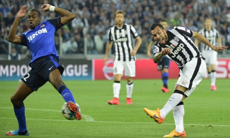 Carlos Tevez gets his shot away despite the attentions of Geoffrey Kondogbia.