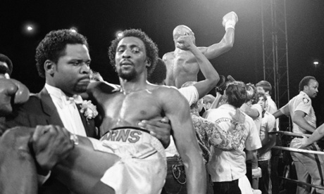 Hearns is carried from the ring as Hagler celebrates.