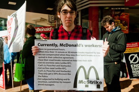 A picketer holds a sign with a list of grievances and issues facing McDonald's workers. There are also fears that without guaranteed hours striking workers may be discriminated against upon returning to work. -- In protest against zero hour contracts, which do not guarantee any number rostered hours in a week, members of the Unite union went on strike against McDonald's after the company failed to return with a satisfactory offer.
