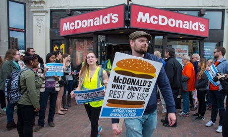Union members march through the streets of Boston as part of the Fight for $15 protests.