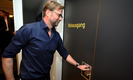 Jürgen Klopp takes the emergency exit after a press conference to confirm his departure from Borussia Dortmund at the end of the season.