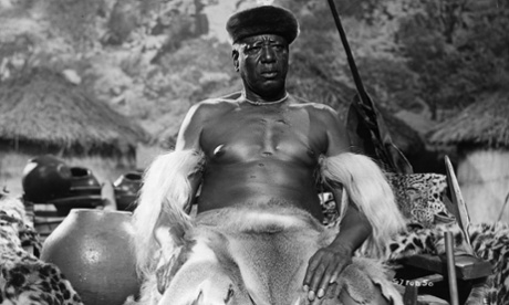 An African tribal chief sits on his throne in a scene from the film Rhodes of Africa