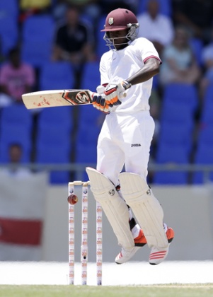 Jermaine Blackwood jumps as he plays a delivery.