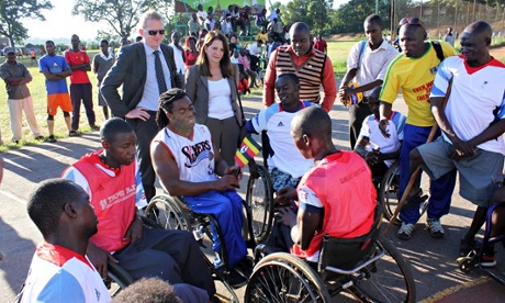 British Paralympic star Ade Adepitan (centre) joins under-secretary for international development Lynne Featherstone in Kampala in 2013.