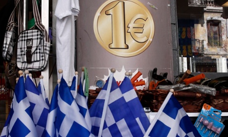 Greek flags for sale at the entrance of a one Euro shop in Athens.