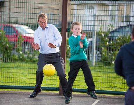 Tim Farron playing football with children at The Adventure playground on the Kirkbarrow estate