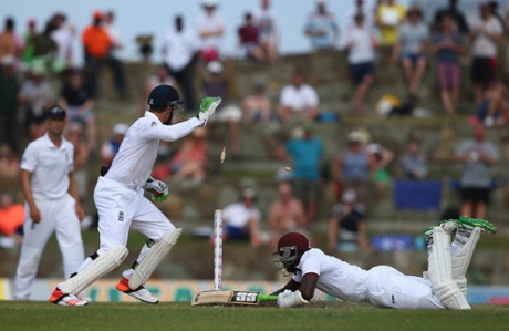 Jos Buttler of England whips the bails off to run out Jerome Taylor of West Indies.