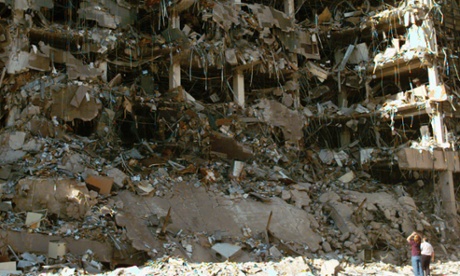 Rescue workers stand in front of the Alfred P Murrah Federal Building after the bombing.