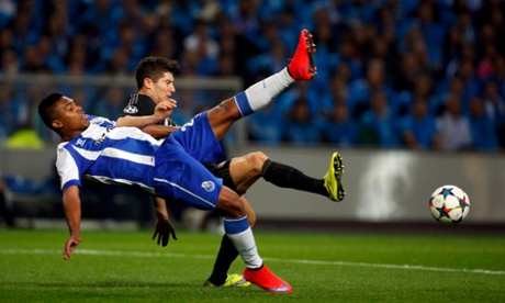 Bayern Munich's Robert Lewandowski and Porto's Alex Sandro go leg to leg as they tussle for the ball.