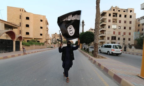 A member of Islamic State waves the group's flag in Raqqa